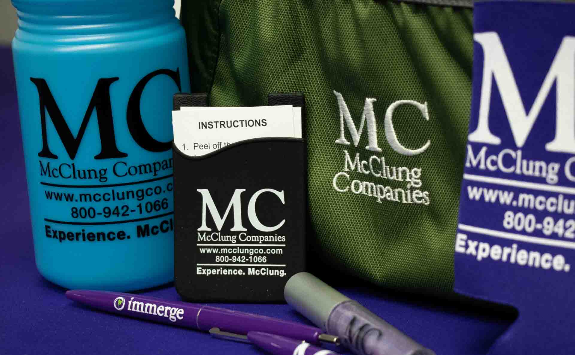 McClung branded promotional materials scattered on table.